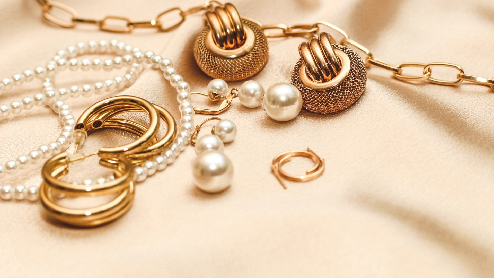 Premium artificial jewellery collection featuring pearl necklaces, gold-plated earrings, statement hoops, and elegant fashion jewellery accessories for women.