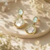 Gold-plated drop earrings featuring mint green Pachi Kundan stones and teardrop Kundan detailing