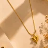 Gold heart pendant necklace with anti-tarnish 18K gold-plated chain on a beige luxury background