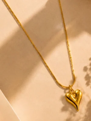 18K Gold Heart Pendant Necklace Anti Tarnish Jewelry Gold heart pendant necklace with anti-tarnish 18K gold-plated chain on a beige luxury background