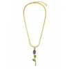 Gold floral pendant necklace with purple and green gemstone accents on a white background