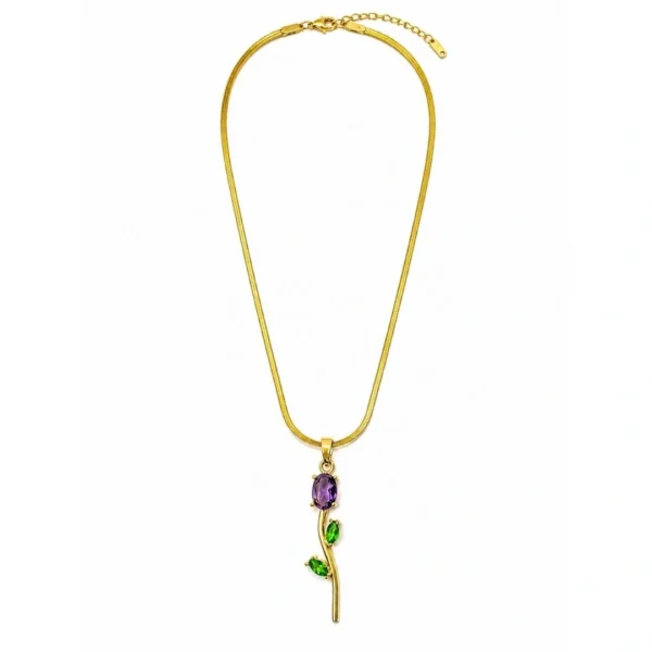 Gold floral pendant necklace with purple and green gemstone accents on a white background