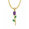 Gold floral pendant necklace with purple and green gemstone accents on a white background
